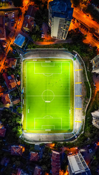 Drone-Captured Aerial View of Soccer Field Amidst Play