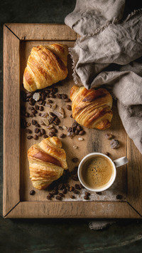 Fresh baked traditional croissants on linen textile