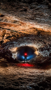 Photographer creates fantasy selfies inside the cave