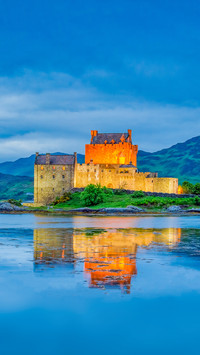 Illuminated Eilean Donan Castle at sunset, Scotland