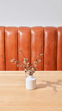 Dry flowers in a vase on a table in a room