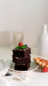 Cropped shot of stack chocolate brownies on plate