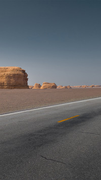 The highway passes through eroded rock formations