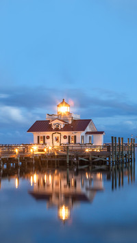 The Roanoke Marshes Lighthouse illuminated against the cloud