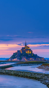 View of famous Le Mont Saint-Michel tidal island at sunset
