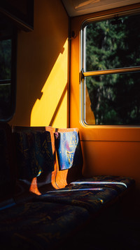Empty train seat in yellow driving tram