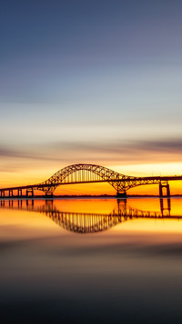 Dawn's glow lights up the river's span