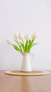 Beautiful bouquet of white tulips in white vase