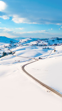Aerial shot of winter road and frozen mountain creek