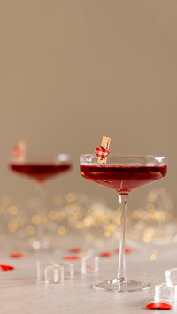 Vertical of two red cocktails with heart shape clips