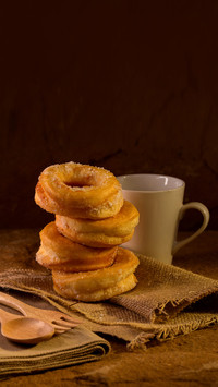 Donuts with sugar on a dark background
