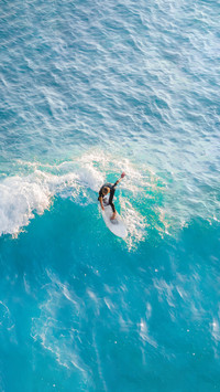 Surfer at the top of the wave in the ocean