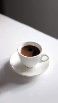 Coffee. Cup of freshly made Espresso isolated on white table