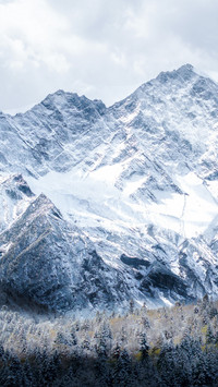 The snow-capped peaks rise high