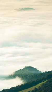 Clouds and mist surround the mountains