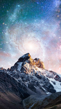 Fantastic starry sky. Snow-capped peaks