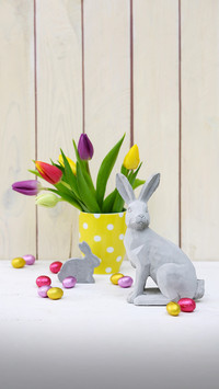 Easter arrangement of concrete rabbit ornament and vase