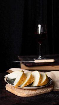 Pieces of melon on wooden boards with a knife