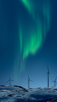 Wind Turbines on a Snowy Hill at Night