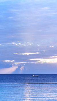 A catamaran anchored in the Caribbean Sea at sunset