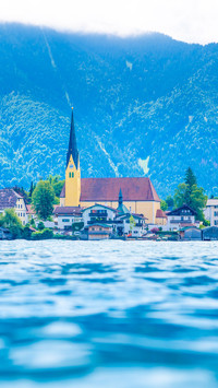Church on other side of blue lake near mountains