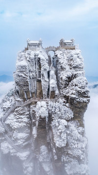Aerial footage of fog and snow on Mount Fanjing in winter