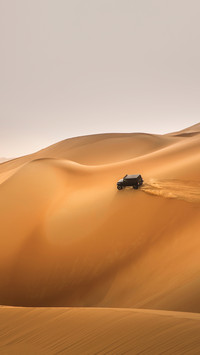 Car driving in Rub al Khali Desert at the Empty Quarter