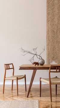 Beige dining room with wooden table and flowers