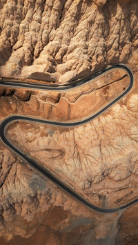 The road winds through the zanda earth forest