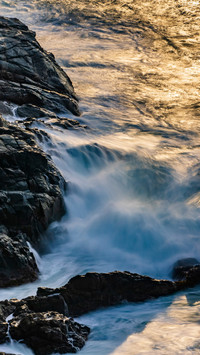 Soft waves gently touch the shore in Sanya at dawn.