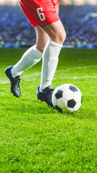 Close-Up On Legs Of Professional Football Player