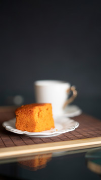 Coffee and orange cake on a black background