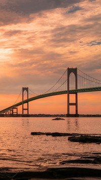 Rising sun and cloudscape over Claiborne Pell Newport Bridge