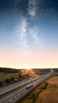 Vehicles on a freeway under an epic star sky and milky way