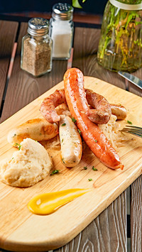German sausage with pickled cabbage and mashed potato