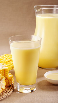 Squeezing corn into juice