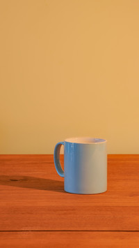 Blue mug on an empty wooden table
