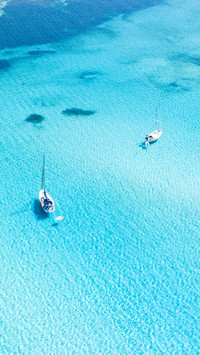 Aerial view of boats sailing on turquoise water