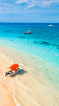 View of the fishing boat in clear blue water at sunset