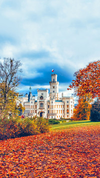 Castle Hluboka nad Vltavou in autumn with red foliage