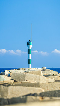 A lighthouse on the coast, blue sky