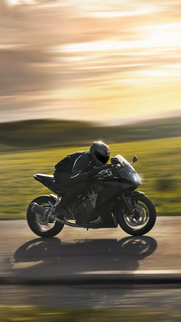Man Riding a Sports Motorbike at Sunset