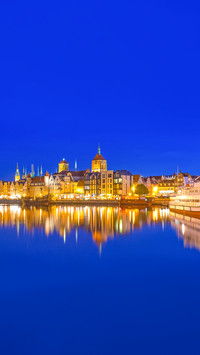 The old town in Gdansk over Motlawa river at dusk