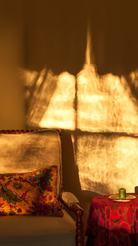 Chair with cushion and a window shadow