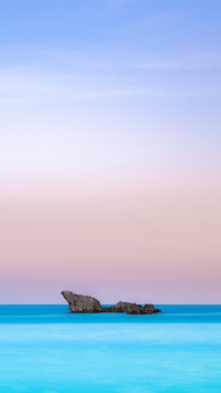 Twin rocks in the sea with pal background