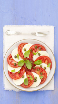 Tomatoes with mozzarella capers and basil