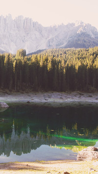 The morning light of the Alps reflects on the lake