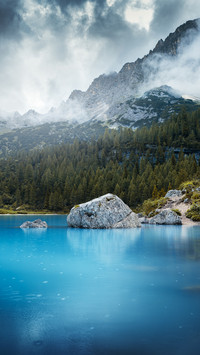 Famous lake Sorapis with high snowy mountains at sunset