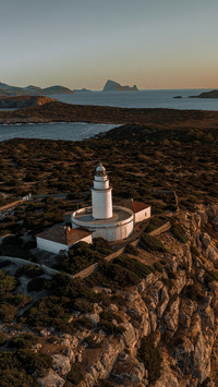 Lighthouse at Sunset on a Tall Cliff Overlooking