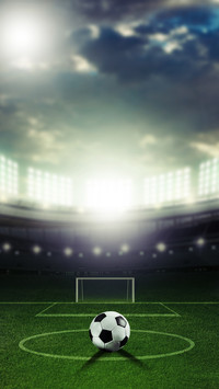 Ball on the green field at soccer stadium